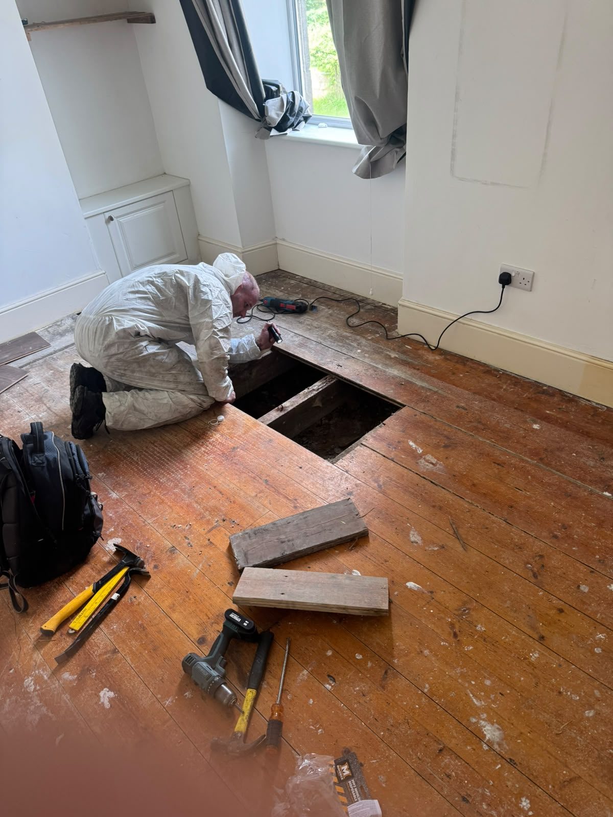 Floor cavity opened to trace rat activity beneath a Glasgow property