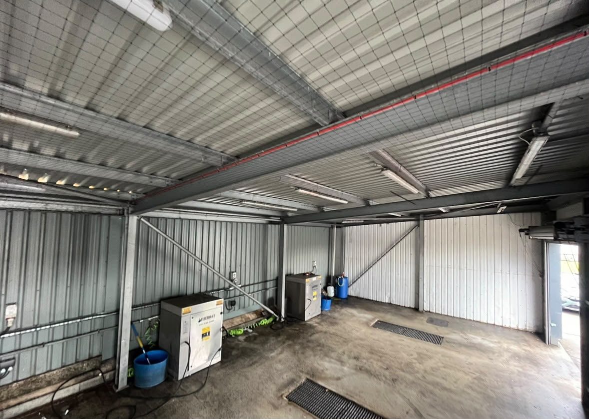 Overhead bird netting protecting an industrial production area