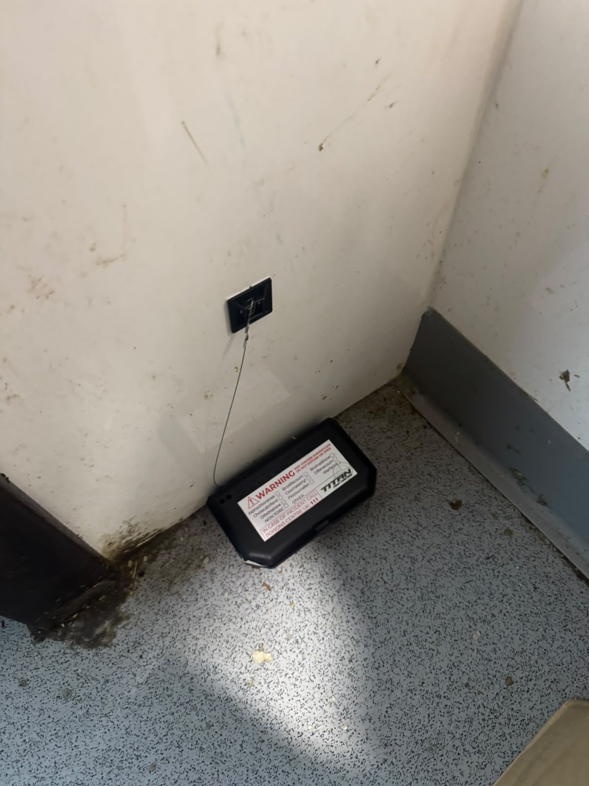 Secured internal rat bait station positioned in a commercial unit