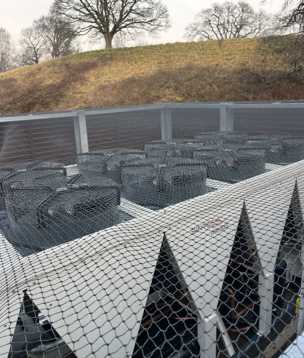 Extensive rooftop bird netting protecting HVAC units from gulls